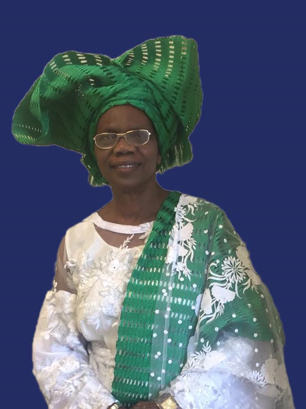 Prophetess Esther Oluwadolapo Owolabi in a green gele and a white lace outfit with a green sash
