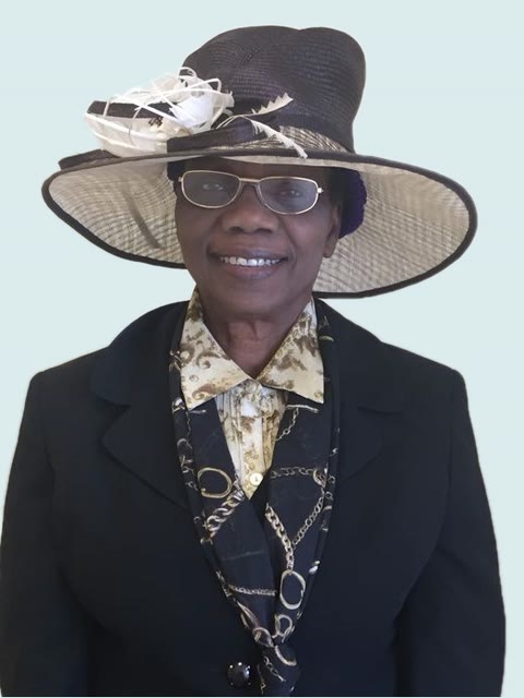 Prophetess Esther Oluwadolapo Owolabi in a wide-brimmed hat and a dark suit